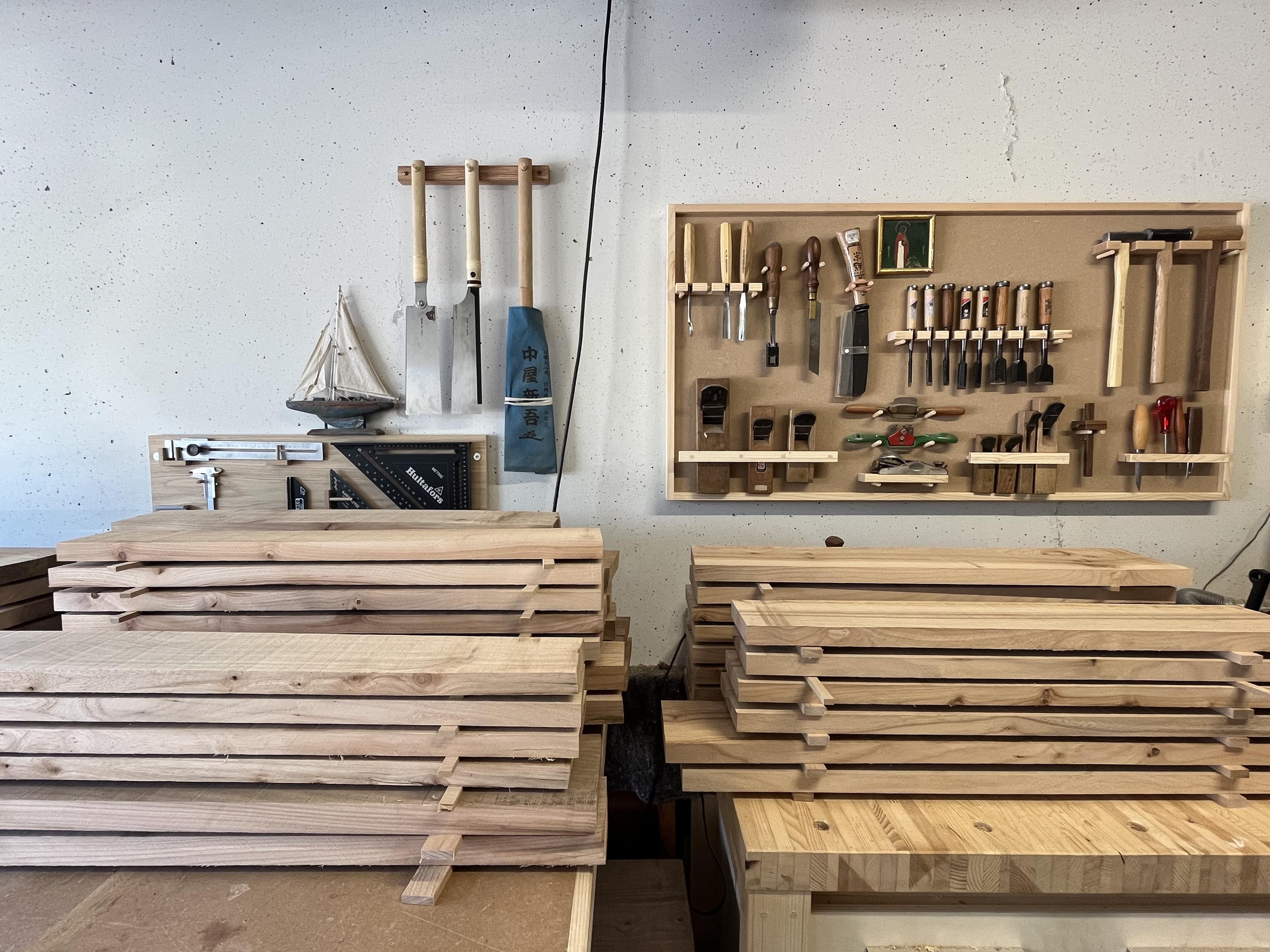 Woodworking tools and prepared boards in the studio