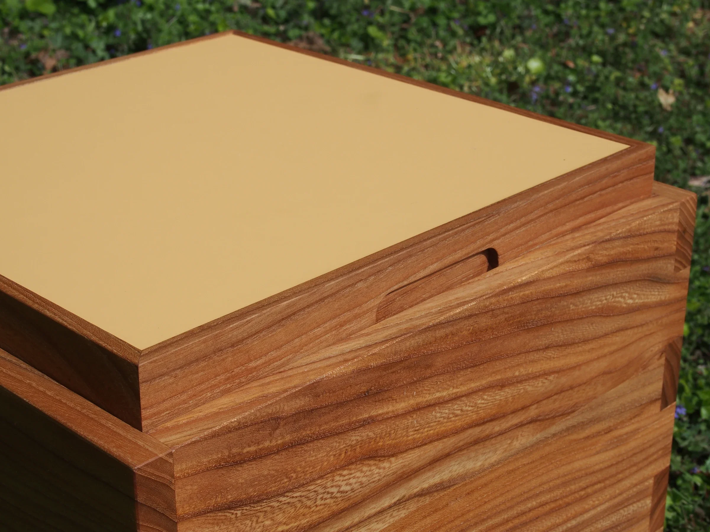 Close-up of the yellow tray, handle and elm joinery