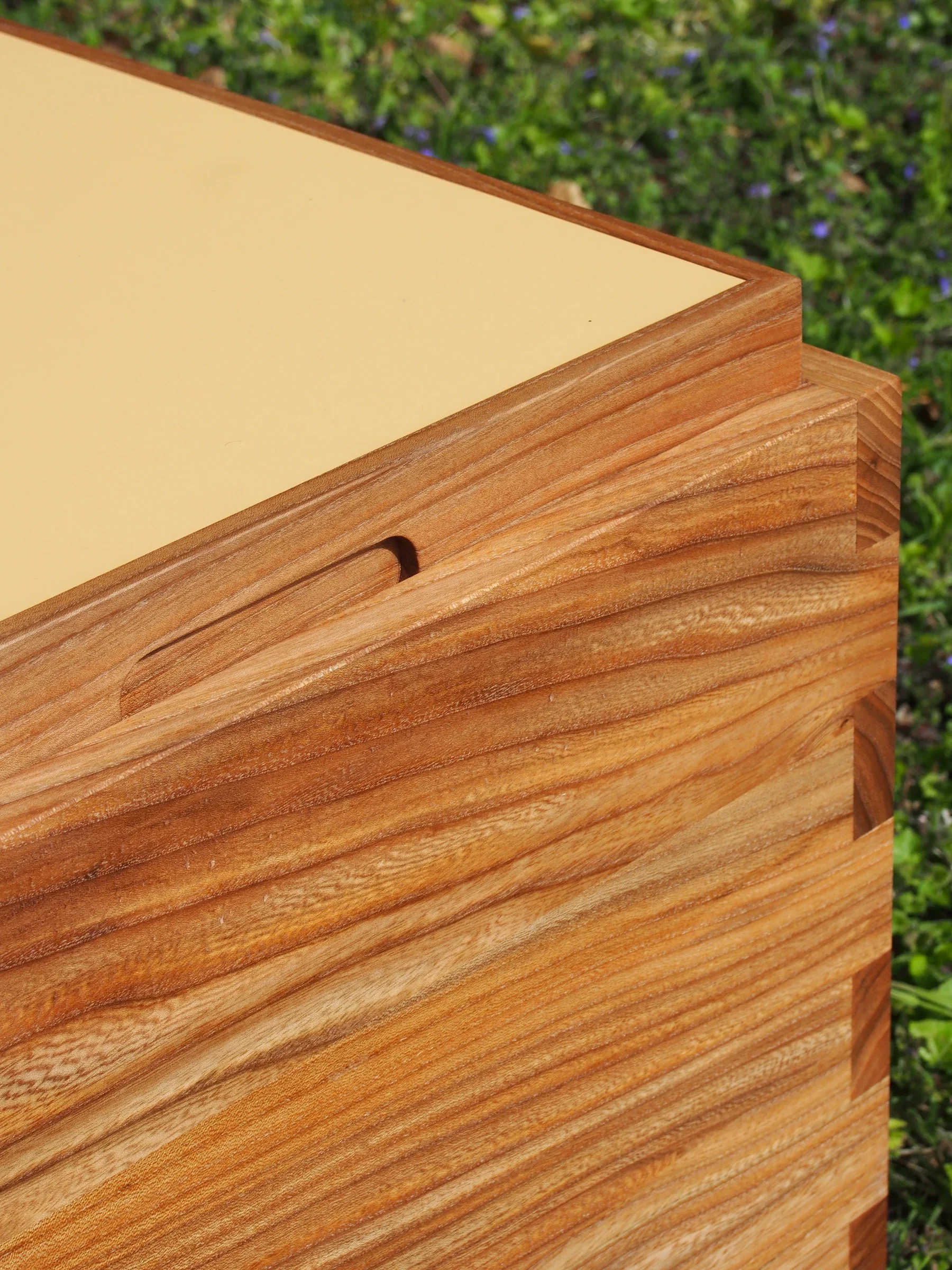 Close-up of the KUBE table tray handle and elm grain